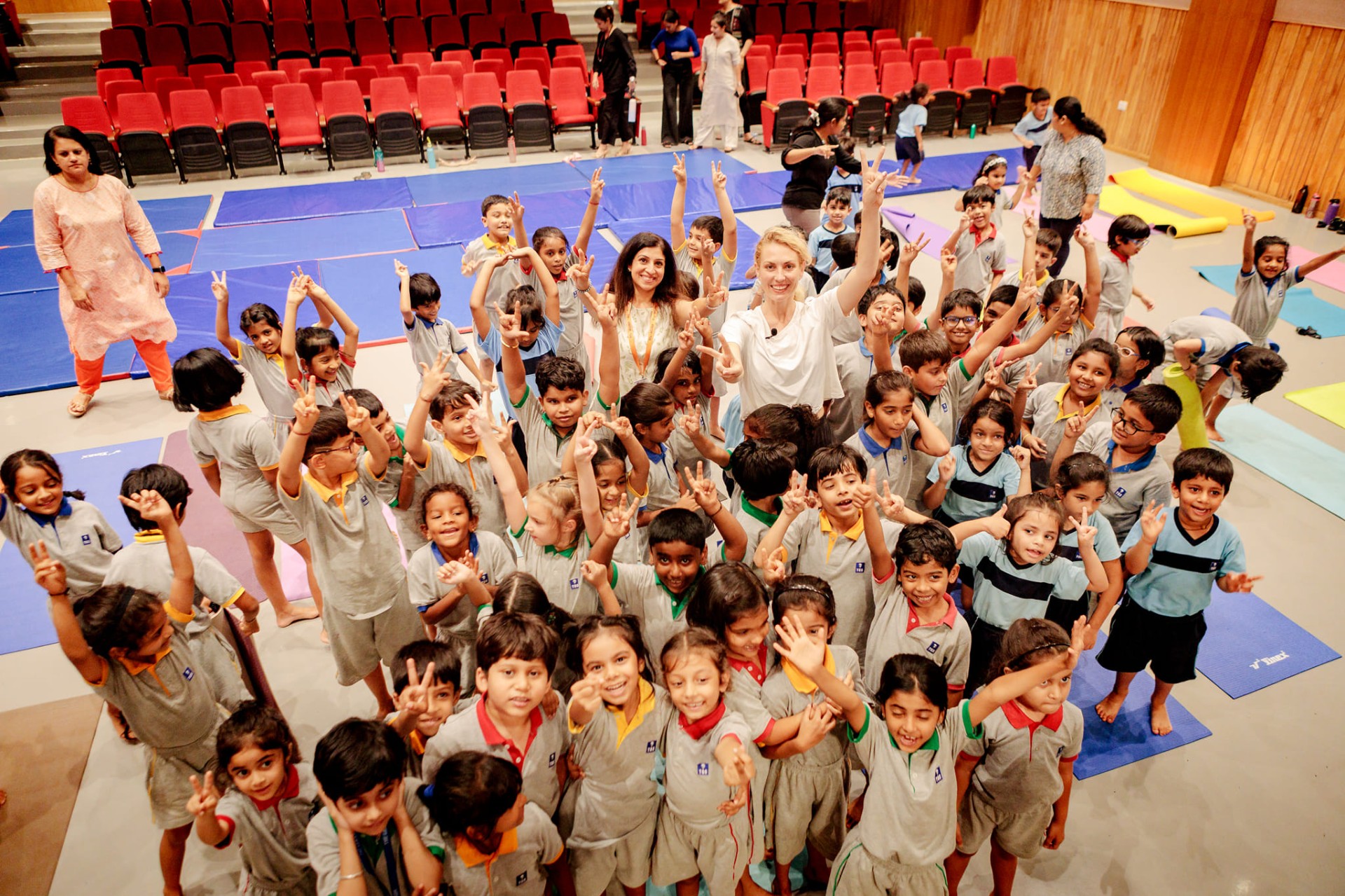 Alizah leading yoga with schoolchildren on International Yoga Day in Goa, India